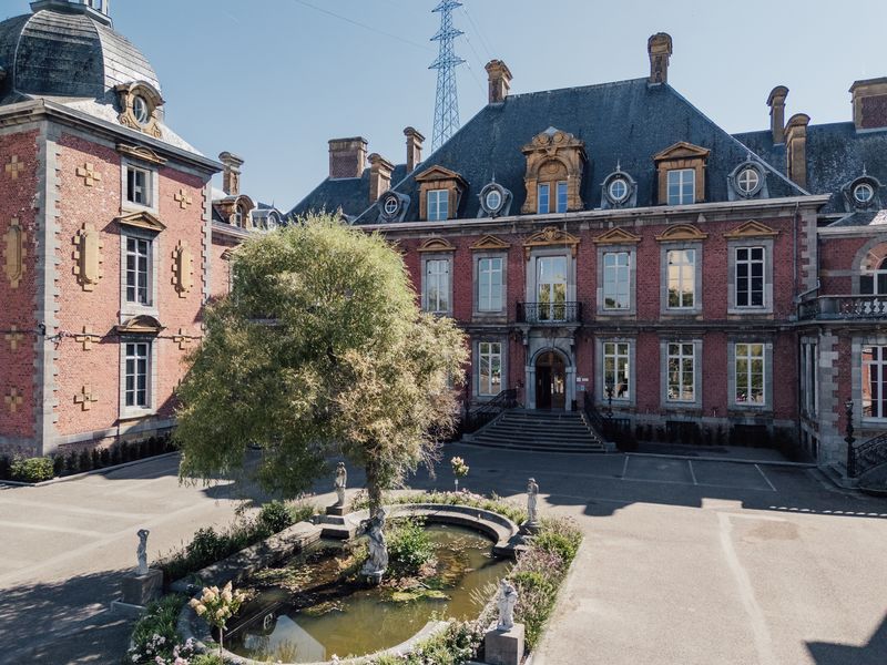 Cour d'honneur et façade en briques du château vues du ciel – Château de la Neuville